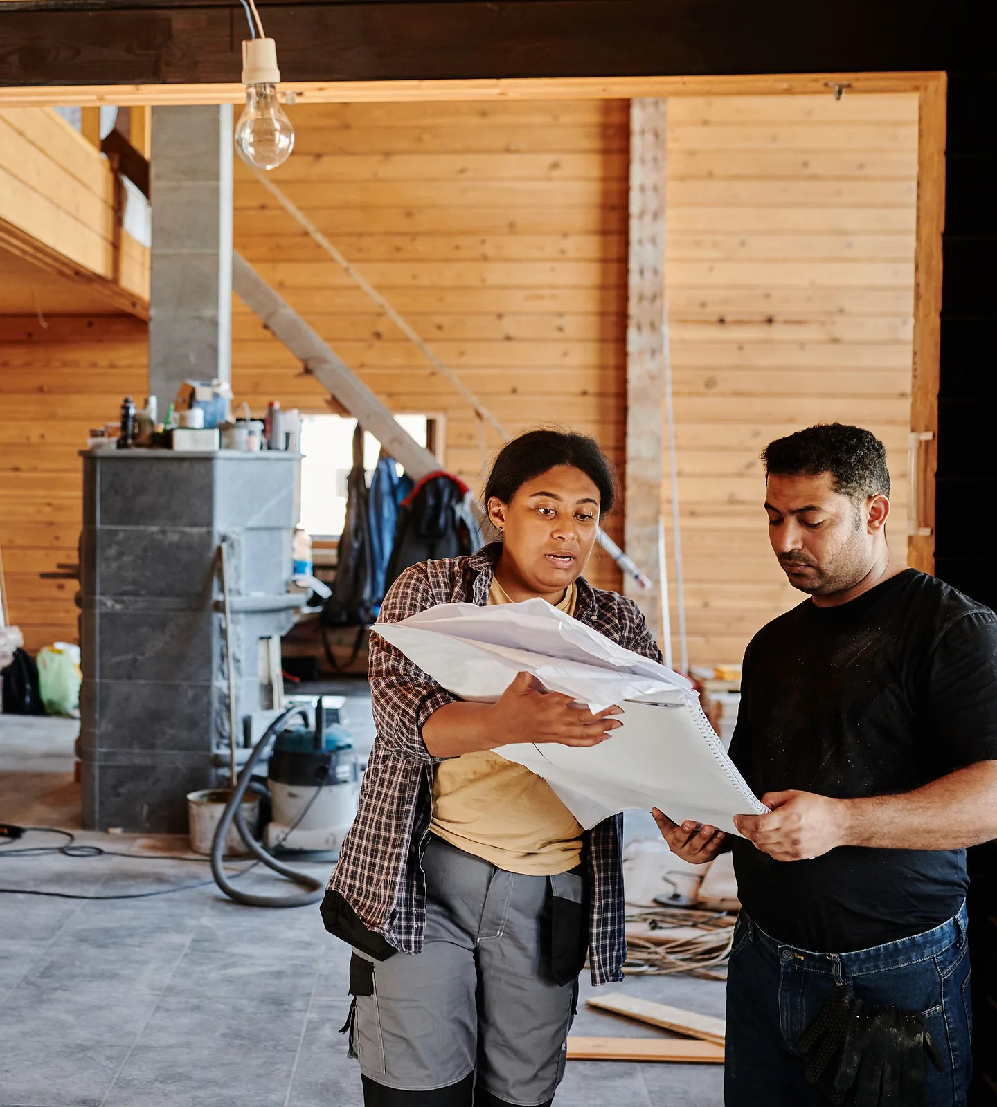 Solar installer talking with a homeowner outside a house